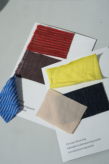 Small fabric swatches arranged on a table for textile sourcing